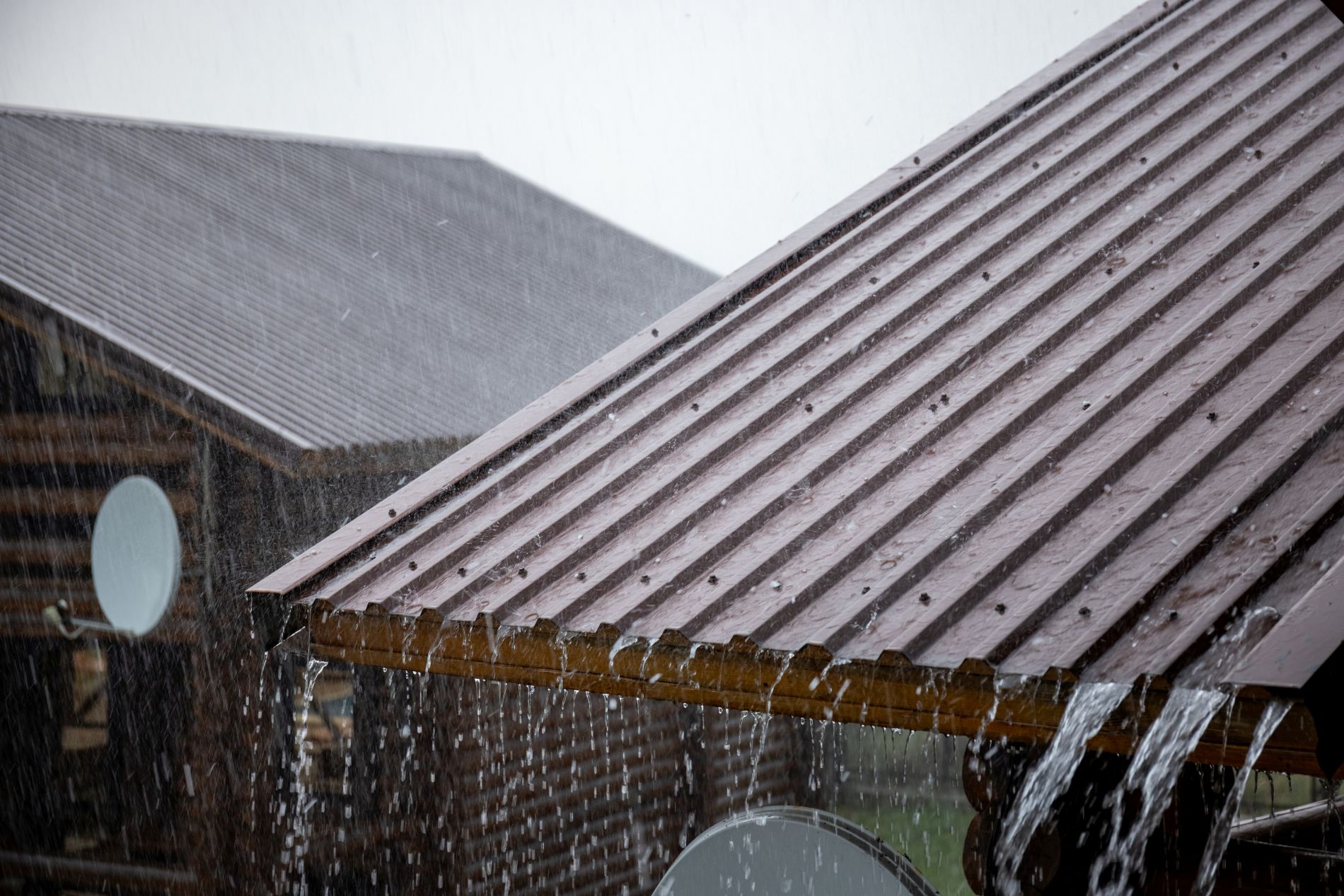 Commercial roof drainage system near equipment and scuppers